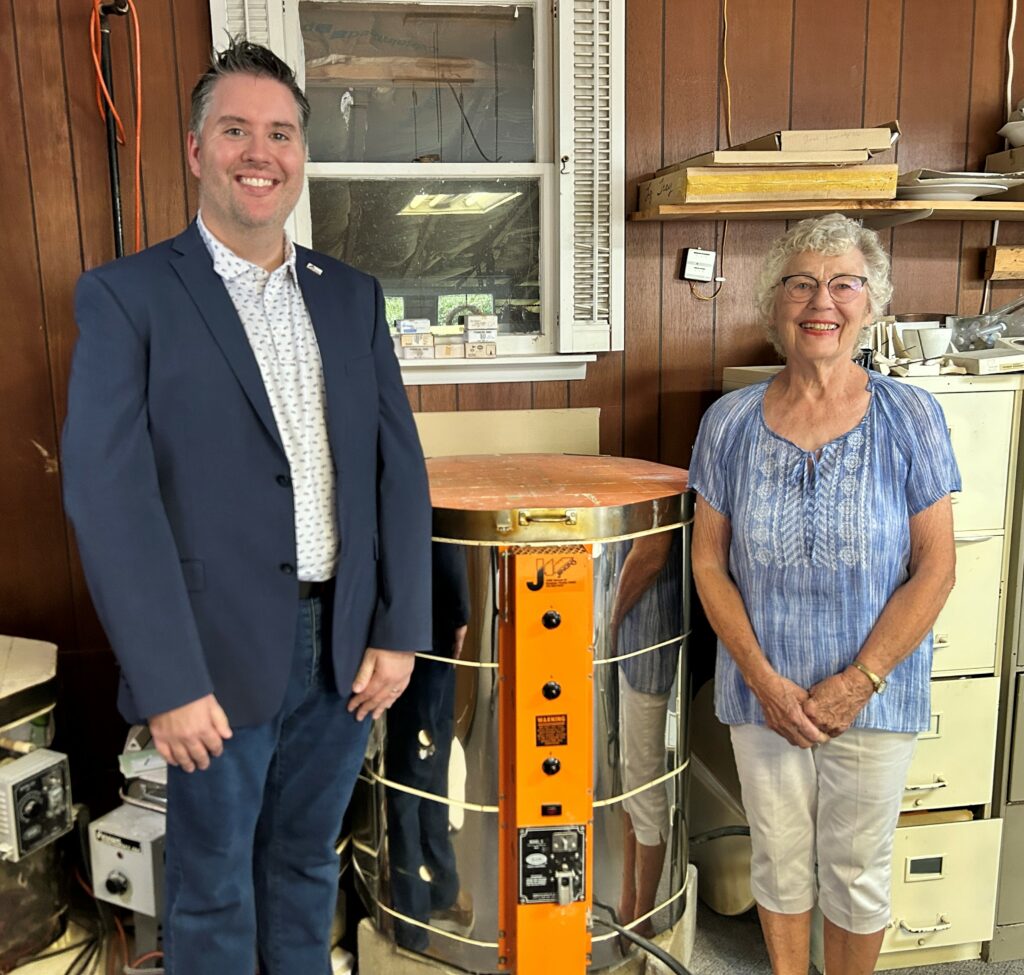 Dr. Tyler Billman, SIC Executive Dean of Academic Services, is pictured with Charlene Whitler of Eldorado and the large kiln she donated to SIC for future art classes.
