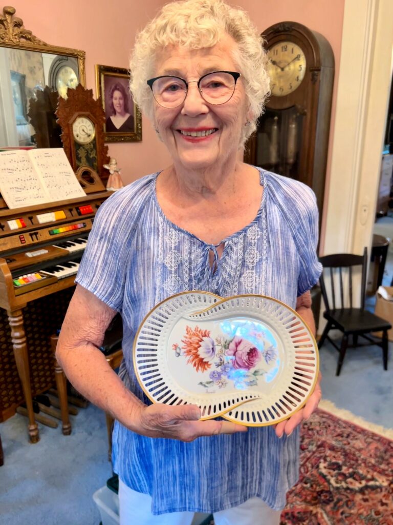 Charlene Whitler of Eldorado shows off one of many plates she has hand painted.