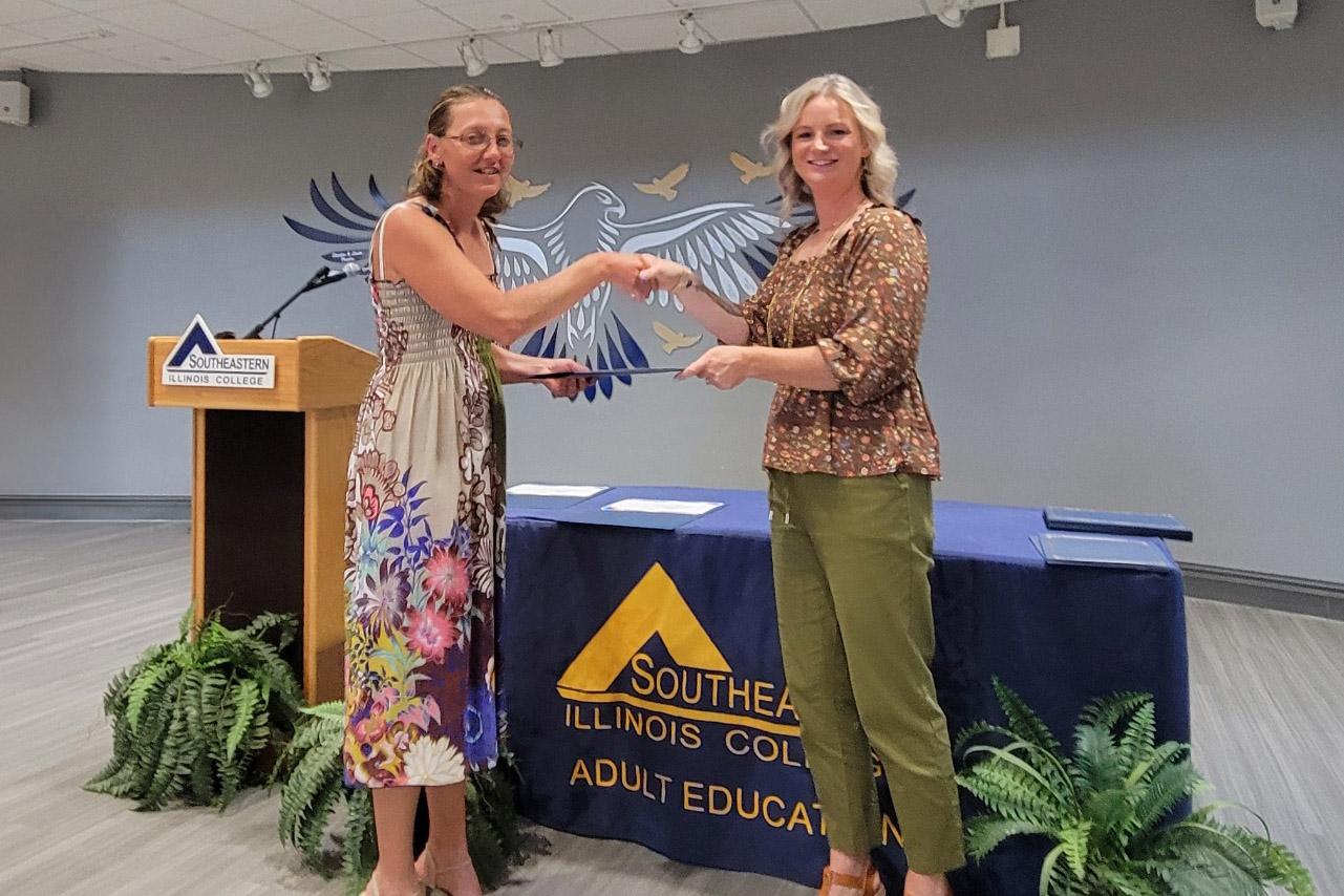 Michelle Bartley receives her high school equivalency diploma at SIC’s first GED graduation ceremony.