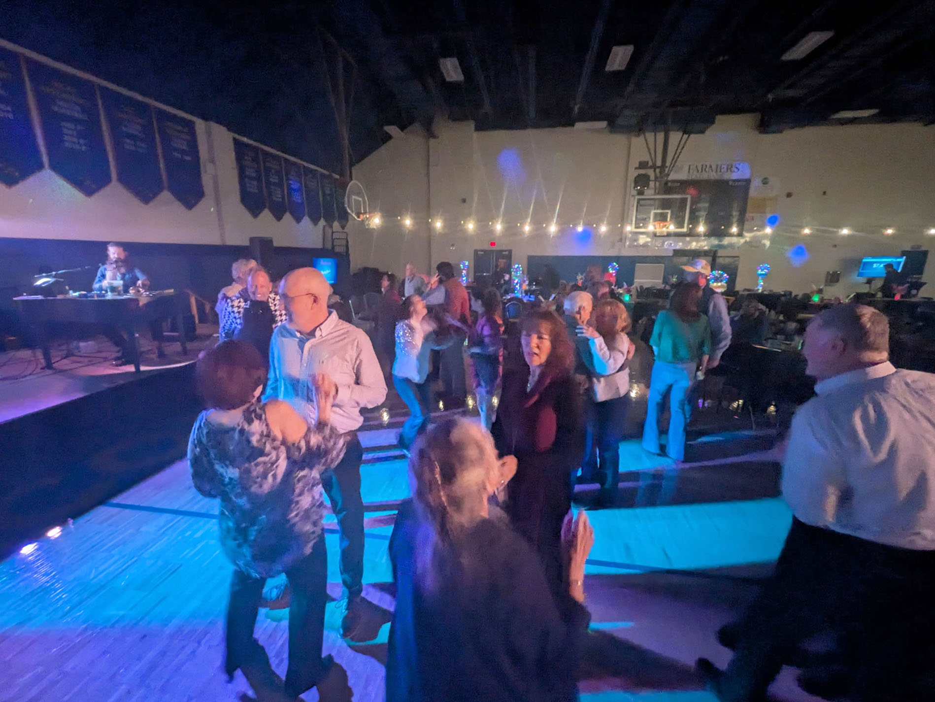 Guests hit the dance floor in front of the stage during the Concert for a Cause: Howl at the Moon Dueling Pianos.