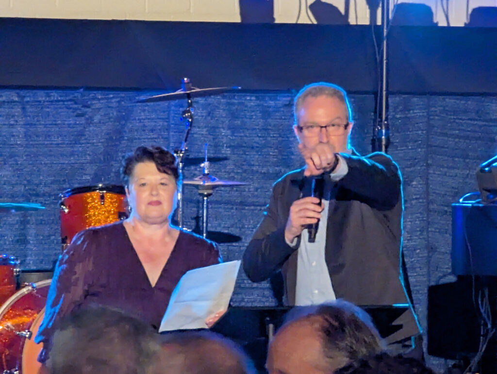 Dr. Karen Weiss, President of Southeastern Illinois College (left), and Tony Keene, CEO of Ferrell Hospital (right), deliver opening remarks at the Concert for a Cause.